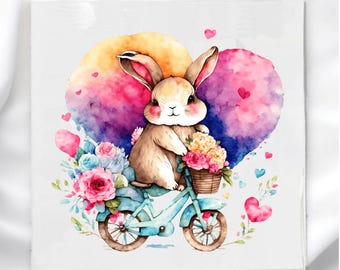 May include: Watercolor illustration of a bunny riding a light blue bicycle, carrying a basket of flowers. The bunny is set against a heart-shaped background with pink, purple, and yellow hues. Pink hearts and flowers are scattered around the image.