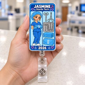 May include: A rectangular badge reel featuring a blue design with the text Jasmine Sterile Tech and 2026. The graphic shows a cartoon sterile technician in blue scrubs, surgical tools, a tray, and wrapped medical supplies.