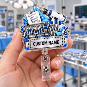 May include: A clear acrylic badge reel featuring a surgical instrument tray graphic with a drill, metal tools, and a note that reads Clean Prep Protect Repeat. The front plate includes a rectangular space with the text CUSTOM NAME in blue.