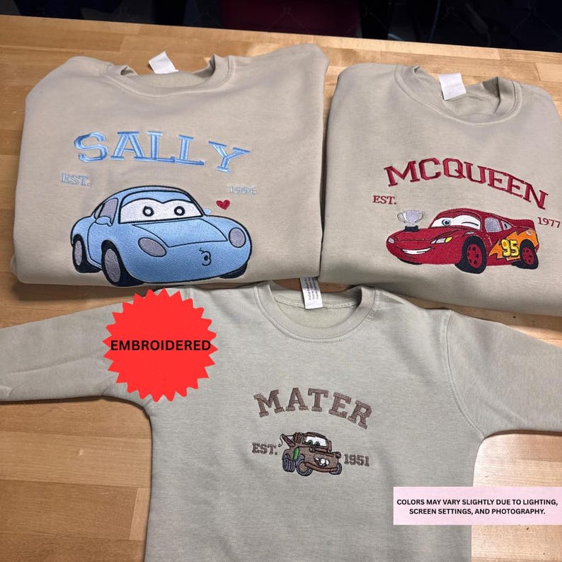 three t-shirts with different cartoon car designs and text, including the names Sally and McQueen.