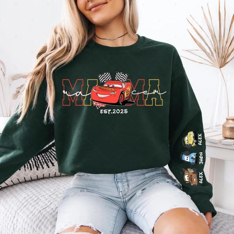 A woman wearing a green sweatshirt with a graphic of a red car and the text "MOMA" printed on it.