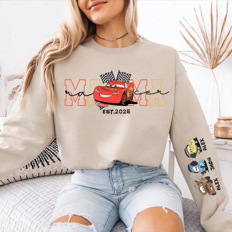 A woman wearing a sweatshirt with a graphic of a red car and the text "Mama" printed on it.