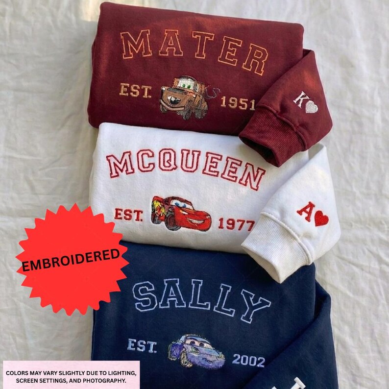 three sweatshirts with the character Sally from the animated movie Cars. The sweatshirts are embroidered with the character's name and the year 1977.