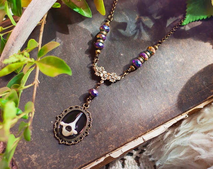 bobcat kitten vertebra cameo necklace with floral detail & purple glass beads