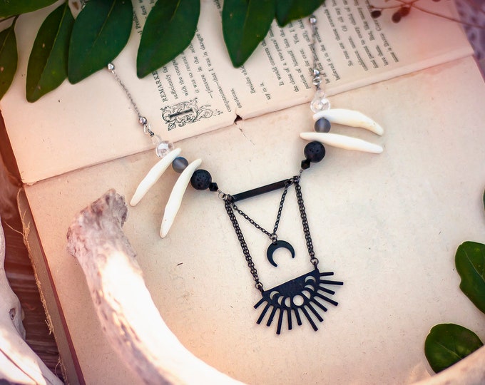 black geometric moon phase necklace with coyote teeth