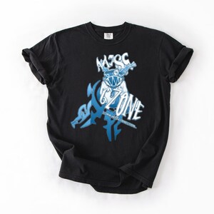 May include: Black t-shirt with a blue and white graphic design. The design features a stylized creature with the text "MZSC" above and "ZONE" below. The shirt is made of a soft material and has short sleeves.