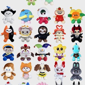 May include: A collection of twenty-eight diverse plush toys arranged in rows. The figures include various stylised characters, animals, and creatures in vibrant colours, featuring unique outfits, accessories, and expressions made from soft fabric materials.