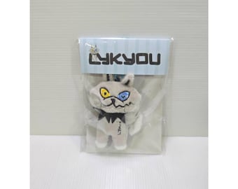 May include: A small, light gray plush cat keychain featuring a black collar, a stitched mouth, and mismatched yellow and blue eyes. The plush is packaged in a clear plastic sleeve with a header card displaying the text LYKYOU in black letters.