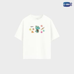 May include: White t-shirt featuring a cartoon dinosaur with the name "Rexa" above it, surrounded by colorful sea-themed illustrations. The design includes starfish, seashells, and a striped candy. The shirt has short sleeves.