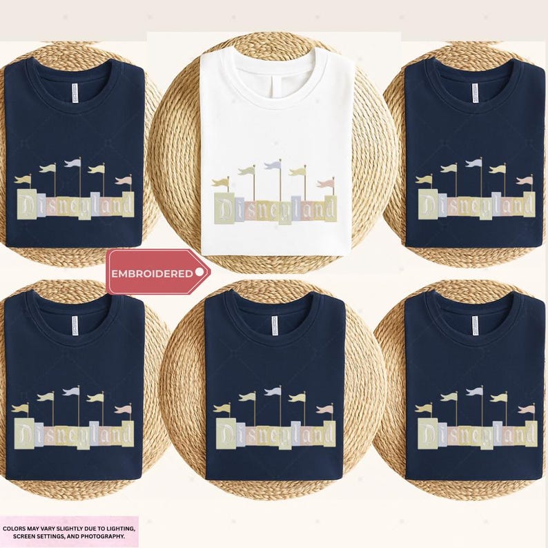 a collection of six t-shirts, each featuring the word "Disneyland" printed on them. The t-shirts are arranged in a grid pattern, with three t-shirts on the top row and three t-shirts on the bottom row. The t-shirts are displayed on a woven mat, and there is a red label in the center of the image that reads "EMBROIDED".