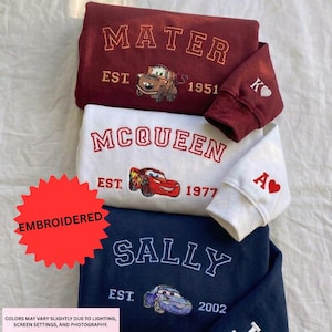 three sweatshirts with the character Sally from the animated movie Cars. The sweatshirts are embroidered with the character's name and the year 1977.