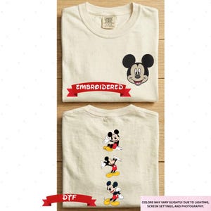 a white t-shirt with a Mickey Mouse design and the text "EMBRODERED" printed on it.