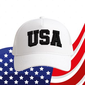 A white baseball cap with the word "USA" printed on it, placed against a background of the American flag.