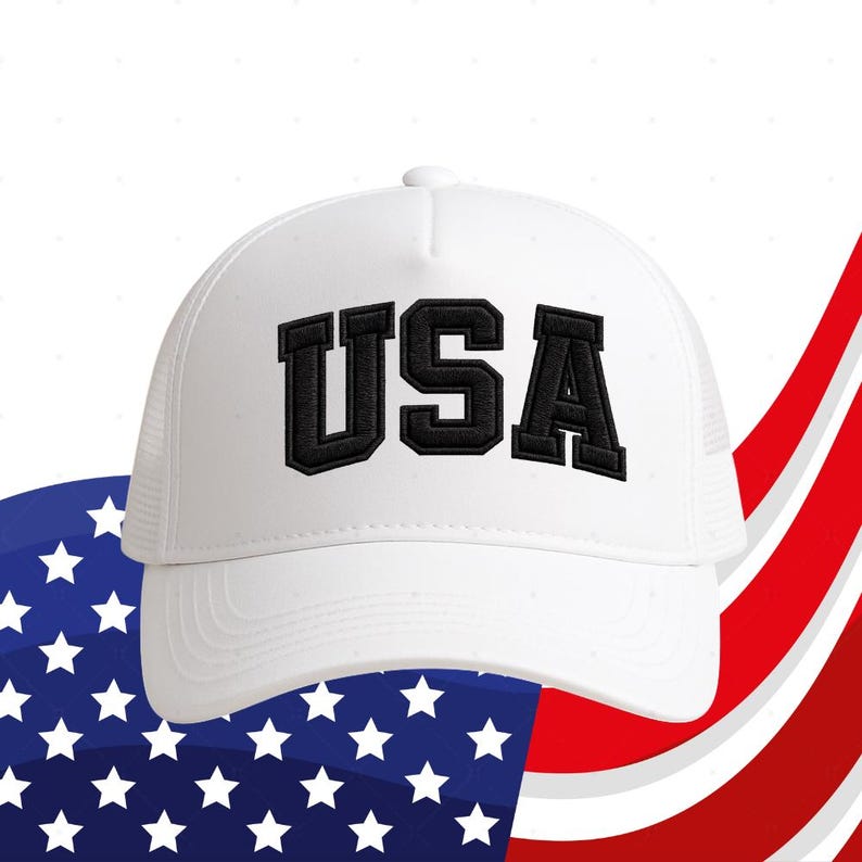 A white baseball cap with the word "USA" printed on it, placed against a background of the American flag.
