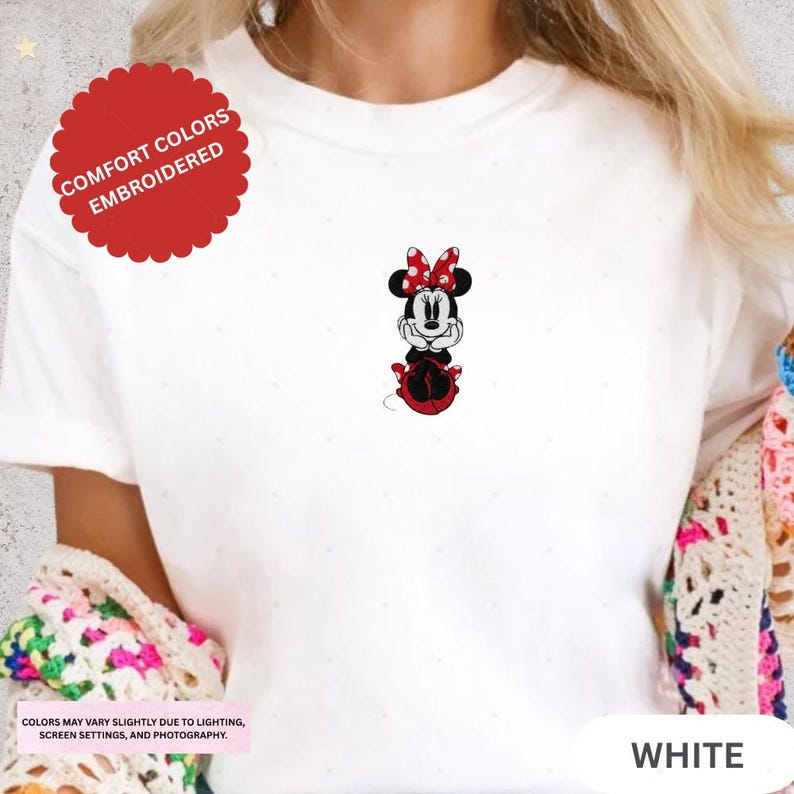 A white t-shirt with a Minnie Mouse embroidered on it.