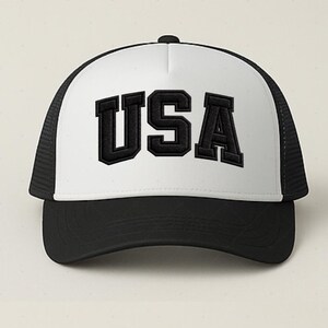 A black and white baseball cap with the word "USA" printed on it.