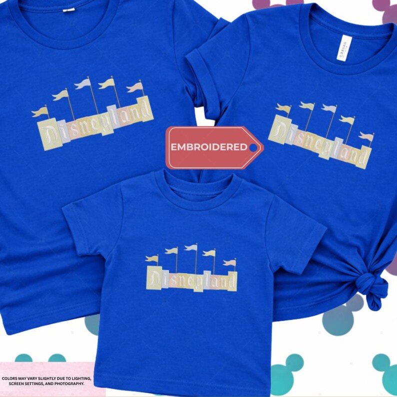 three blue t-shirts with the word "Disneyland" printed on them, along with a red embroidered label that reads "EMBROIDED".