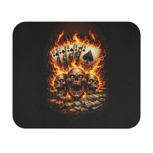 May include: A black mouse mat with a fiery design. It features three skulls, playing cards, money, and poker chips. The playing cards show a royal flush in spades, with flames engulfing the skulls and cards.