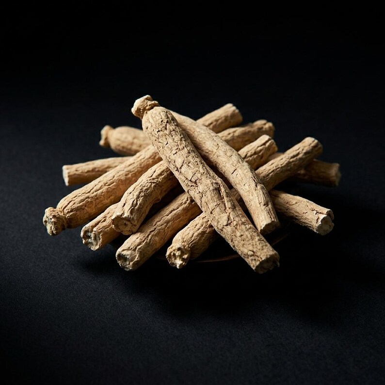 May include: A cluster of dried, light tan ginseng roots with a rough, wrinkled, and fibrous texture. The roots are arranged in a radial pattern, showcasing their cylindrical shape and woody appearance against a solid black background.