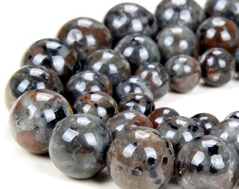 May include: A strand of round, black and grey gemstone beads. The beads have a speckled, iridescent finish.