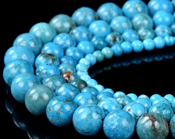 May include: A strand of turquoise beads in various sizes, ranging from small to large. The beads are a vibrant blue color with brown and black marbling throughout.