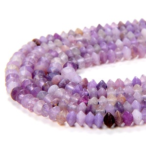 May include: A strand of purple amethyst beads with a faceted, pointed shape. The beads are strung on a clear thread and are approximately 6mm in diameter.