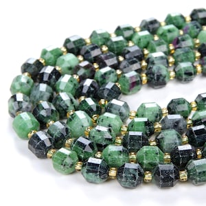 May include: A strand of green and black gemstone beads with gold accents. The beads are faceted and have a unique, irregular shape.