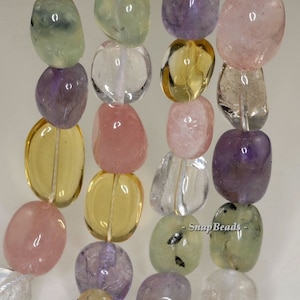 May include: A strand of smooth, tumbled gemstone beads in various colors, including green, clear, yellow, pink, and purple. The beads are oval-shaped and have a natural, polished finish.