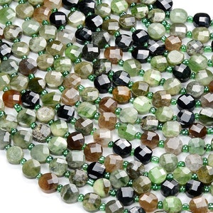 May include: A strand of green, brown, and black gemstone beads. The beads are faceted and have a round shape. The beads are strung on a clear elastic cord.