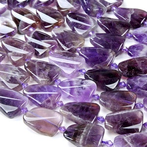 May include: A strand of purple amethyst gemstone beads, each bead is a unique, irregular, faceted, teardrop shape.