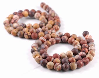 May include: A strand of brown, red, and white patterned round beads. The beads are strung on a clear thread and are arranged in a circle.