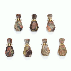 May include: Six small, faceted, gemstone bottles with gold stoppers. The bottles are brown, green, and red with a marbled pattern.