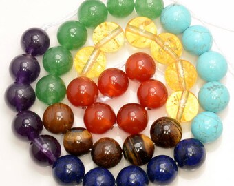 May include: A set of round, smooth gemstone beads in seven colors, arranged in a rainbow pattern. The beads are amethyst, green aventurine, carnelian, tiger's eye, lapis lazuli, turquoise, and amber.