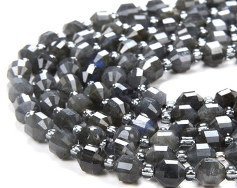 May include: A strand of faceted black labradorite beads with silver accents. The beads are arranged in a circular pattern and have a dark, iridescent sheen.