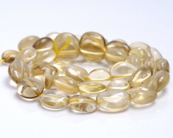 May include: A strand of translucent, light brown gemstone beads. The beads are oval shaped and have a smooth, polished finish.