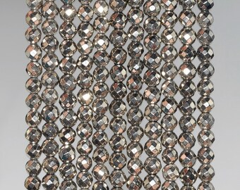 May include: A strand of silver-toned faceted beads. The beads are round and have a metallic finish. The beads are strung on a clear thread.