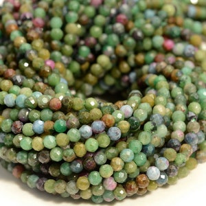 May include: A strand of faceted green gemstone beads. The beads are small and have a variety of shades of green, including emerald green, teal, and olive green.