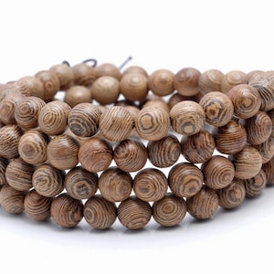 May include: A strand of brown wooden beads with a natural wood grain pattern. The beads are round and have a smooth finish.