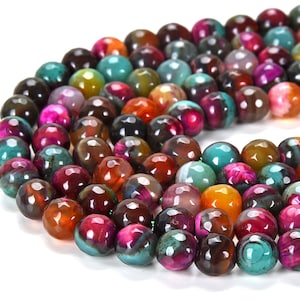 May include: A strand of colourful agate beads. The beads are round and have a faceted finish. The colours of the beads are a mix of green, brown, orange, pink, and black.