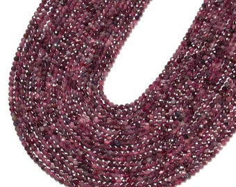 May include: A long strand of small, round, faceted beads in a deep, rich burgundy-red color. The beads are arranged in a U-shape, showcasing their uniform size and the reflective, multi-faceted surface texture of each individual gemstone bead.
