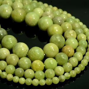 Op de afbeelding: Een streng ronde, groene jade kralen in verschillende maten. De kralen zijn glad en gepolijst, met een natuurlijke, aardse uitstraling.