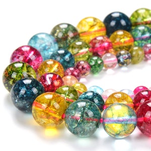 May include: A strand of colorful, iridescent gemstone beads. The beads are round and have a variety of colors, including blue, green, yellow, red, and pink. The beads are strung on a clear string.