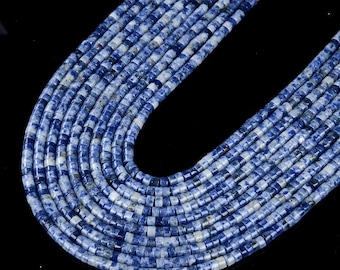 May include: A strand of blue and white gemstone beads. The beads are round and have a speckled pattern. The beads are strung on a clear thread.