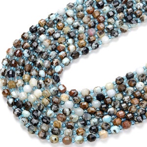 May include: A strand of faceted gemstone beads in shades of brown, blue, and white. The beads are approximately 6mm in size and have a natural, irregular shape.