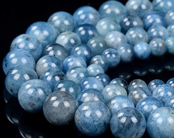 May include: A strand of round, light blue aquamarine beads. The beads are smooth and polished, with a slight shimmer.