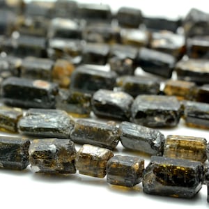 May include: A strand of dark green and black tourmaline beads, each bead is faceted and has a rough, natural texture.