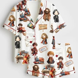 May include: A white short-sleeve pajama set with red piping featuring a repeating cartoon print of Harry Potter characters, steam trains, wands, and letters. The pattern includes various magical items and text such as WANDS and Harry Potter.