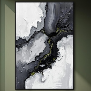 May include: Abstract art print in a black frame. The artwork features a textured design with shades of white, gray, and black, with hints of green. The composition resembles a topographical map or geological formation, creating a modern aesthetic.