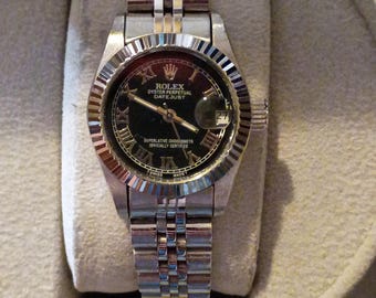 Women's Ladies Rolex Datejust 26mm black bezel and stainless steel band.
