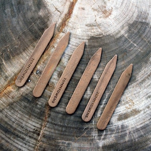 May include: Six wooden collar stays with the text "TOMMY HILFIGER" engraved on each one.
